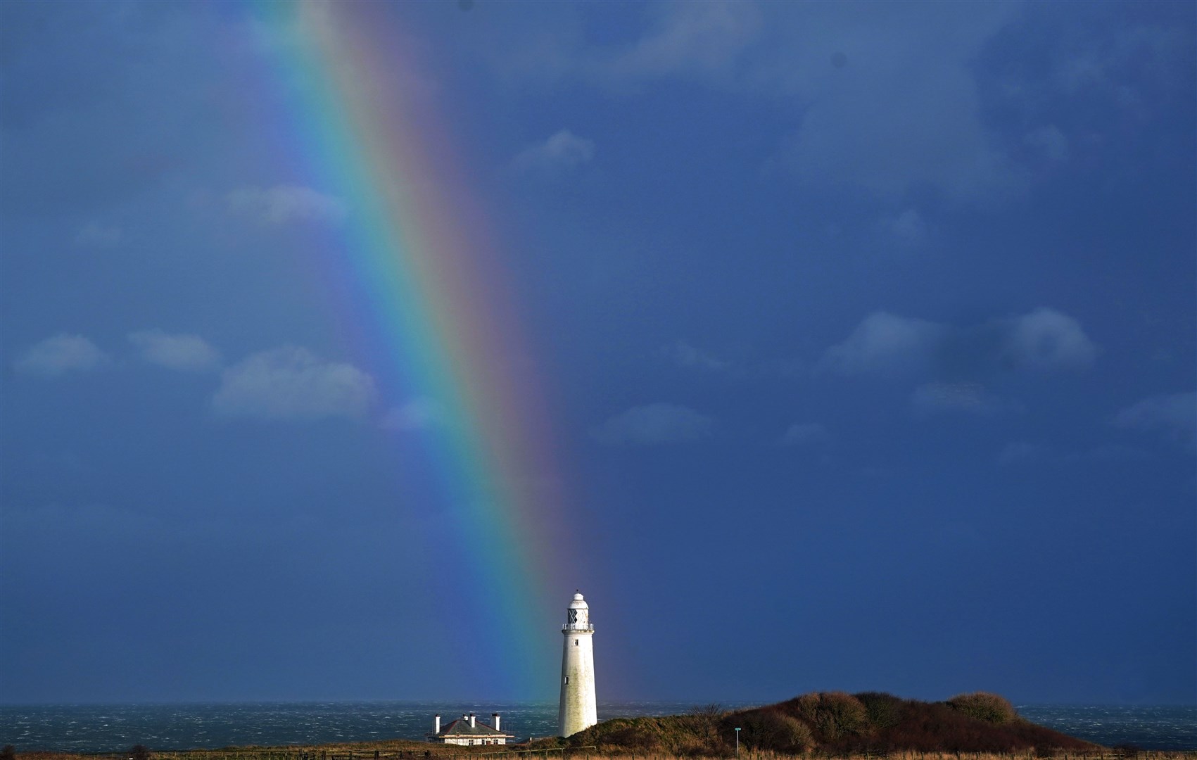 A rainbow over St Mary’s Lighthouse in Whitley Bay, Tyne and Wear, ahead of Storm Dudley (Owen Humphreys/PA)