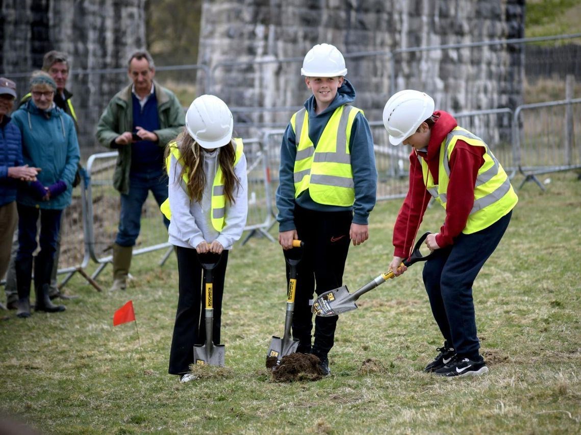Pupils from Strathdearn Primary School officially break ground on the site, which is next to the railway viaduct at the northern end of Tomatin.