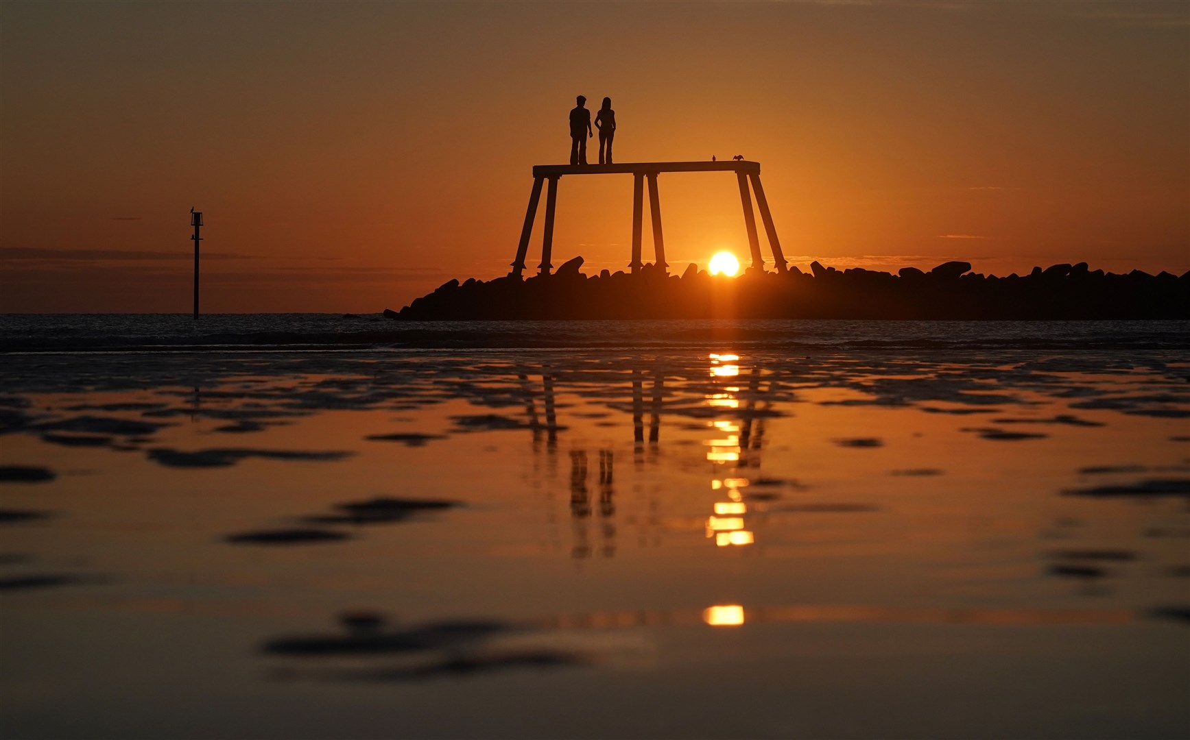 Sean Henry’s The Couple Statue at Newbiggin-by-the-Sea in Northumberland (Owen Humphreys/PA)