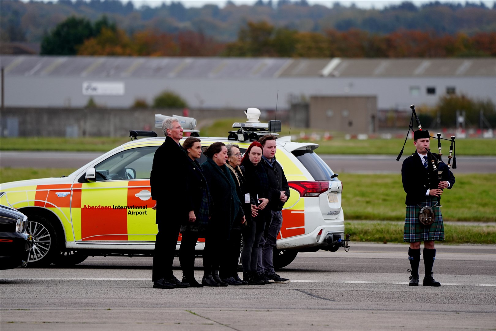 Members of the family and acting Alba leader Kenny MacAskill (left) greet the coffin (Jane Barlow/PA)