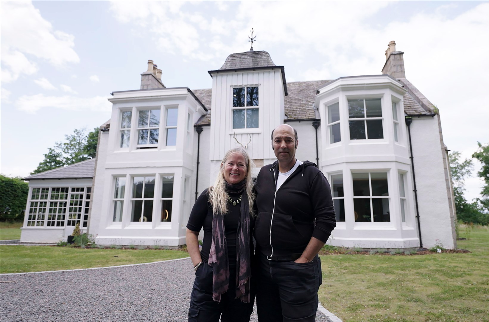 Dianne and Salem in front of their stunning home a short distance from Aviemore.