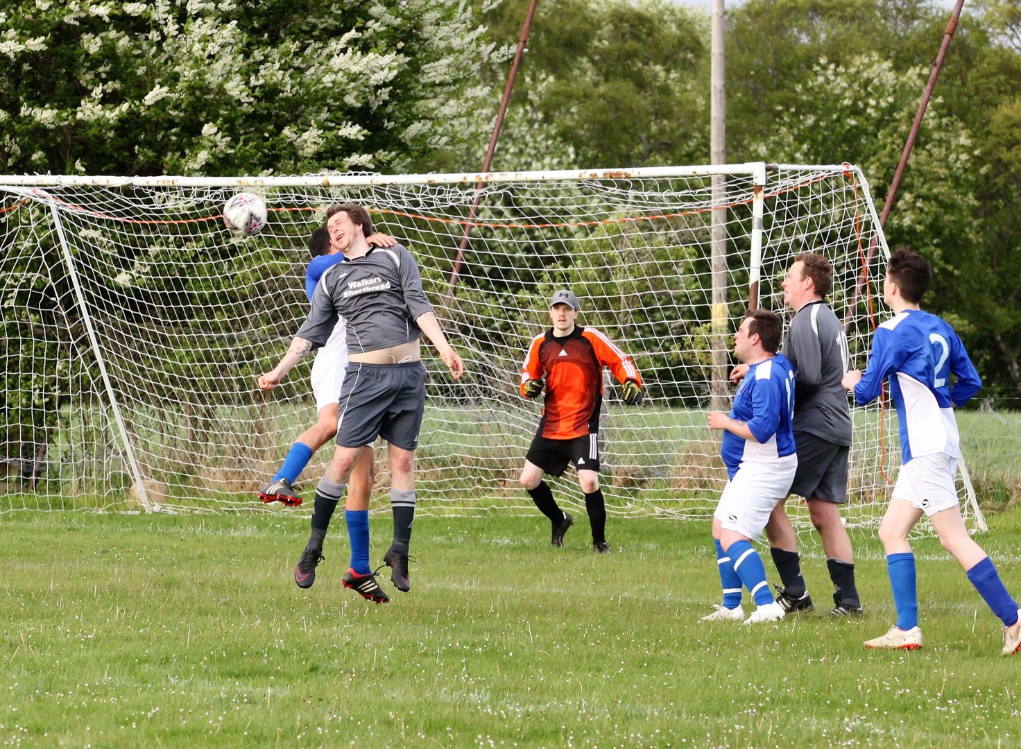 Abernethy’s Blair Johnston gets his head to the ball despite some close interest.
