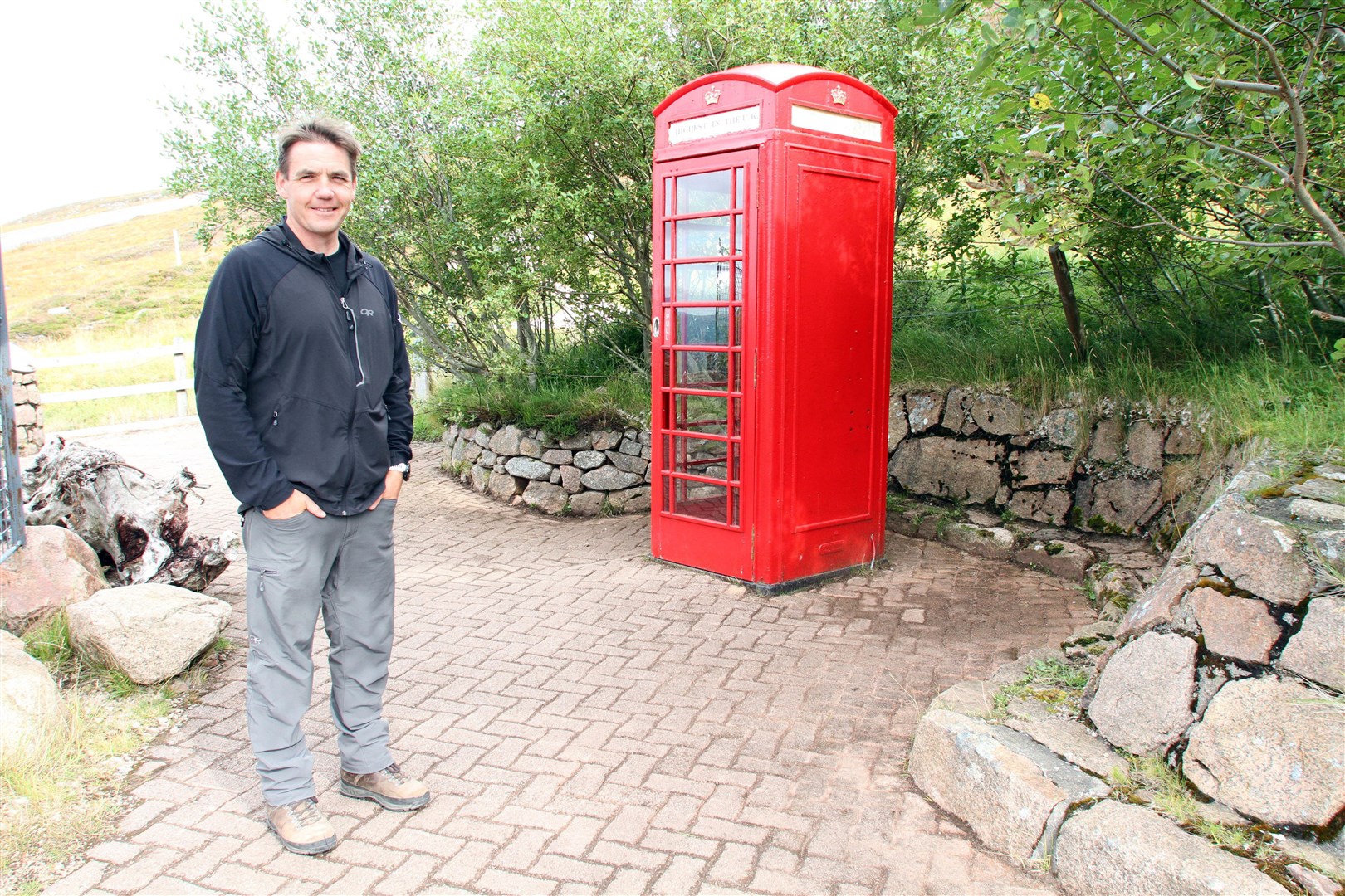 Cairngorm ranger Ruari Macdonald with the red public phone box - the highest in the UK - at Cairngorm Mountain.