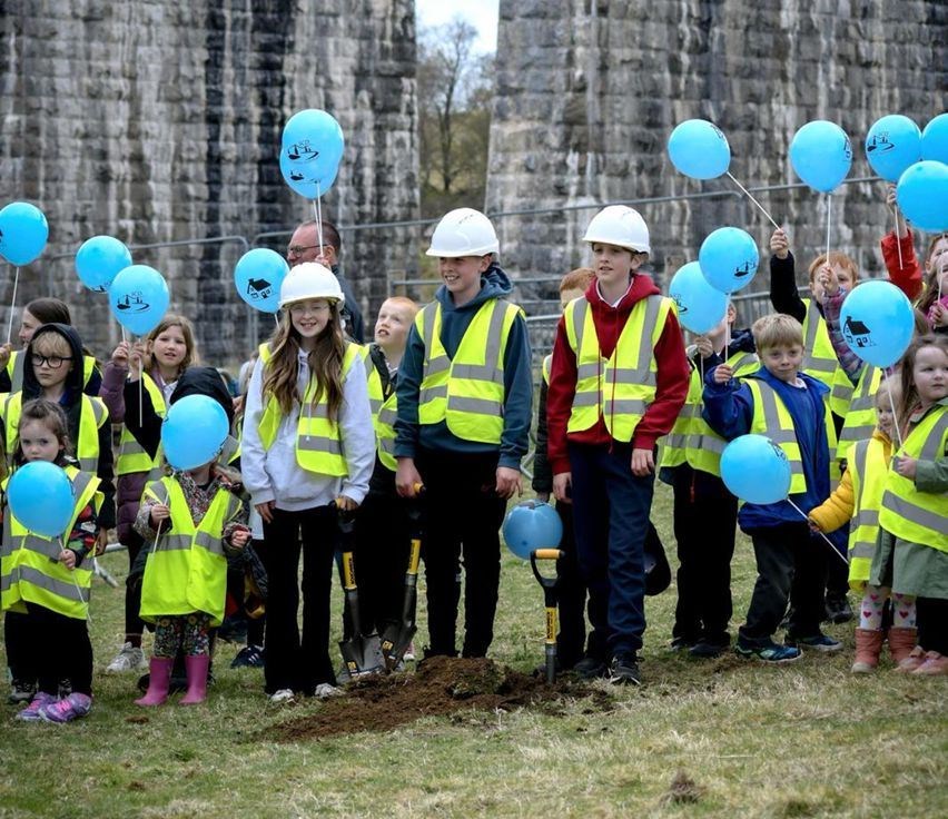 Pupils from Strathdearn Primary School officially break ground on the site, which is next to the railway viaduct at the northern end of Tomatin.