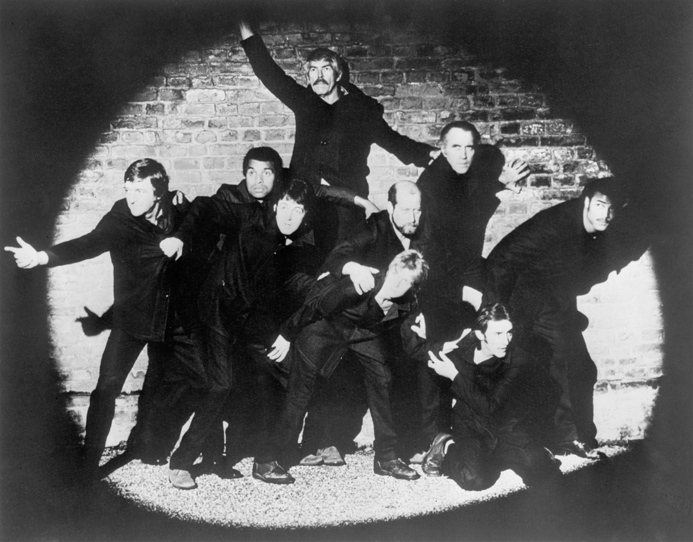 From left, BBC personality Michael Parkinson, singer Kenny Lynch, actor James Coburn (behind), Paul McCartney (below), MP Clement Freud, Linda McCartney, actor Christopher Lee, singer-songwriter Denny Laine (below) and boxer John Conteh. (Clive Arrowsmith/PA)