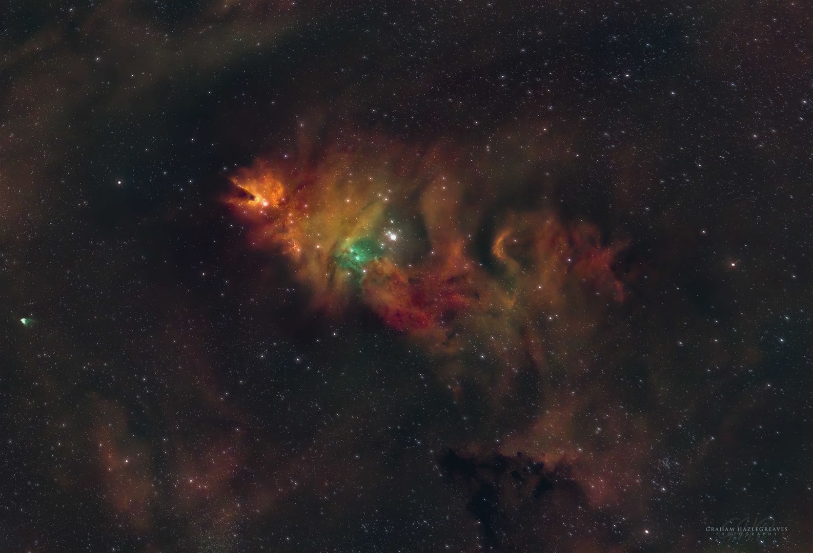 The Cone Nebula and Christmas Tree cluster lie some 2,350 light years from earth in the constellation of Monoceros. It is an emission nebula and star cluster – the colour green shows the oxygenrich gas clouds, red the hydrogen rich areas and the ambers/orange are sulphur rich dust clouds.
