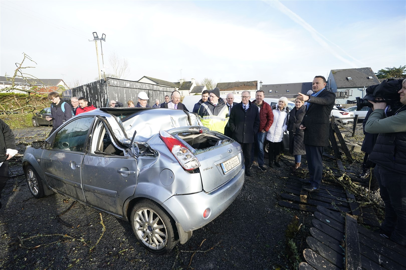 Taoiseach Leo Varadkar views a car which was damaged by a tree in Leitrim Village in Co Leitrim, after a tornado and high winds on Sunday (Niall Carson/PA)