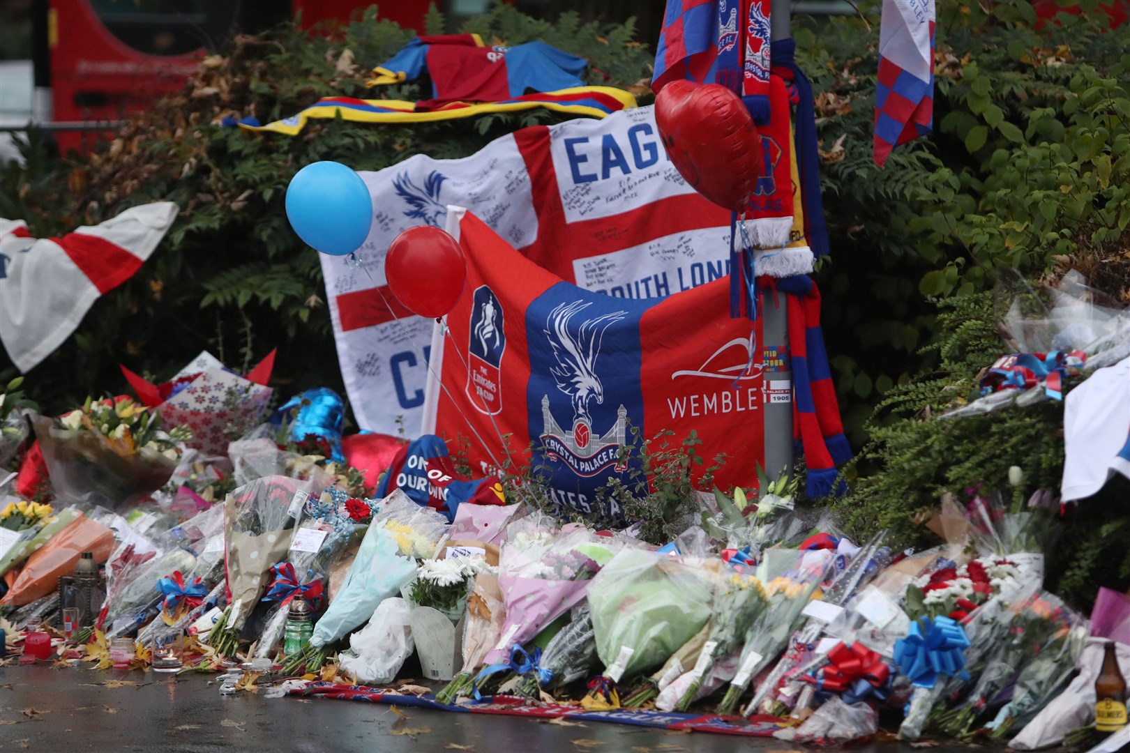 Floral tributes and Crystal Palace football colours were left near the scene where a tram crashed, killing seven people, in Croydon, south London (Steve Parsons/PA)