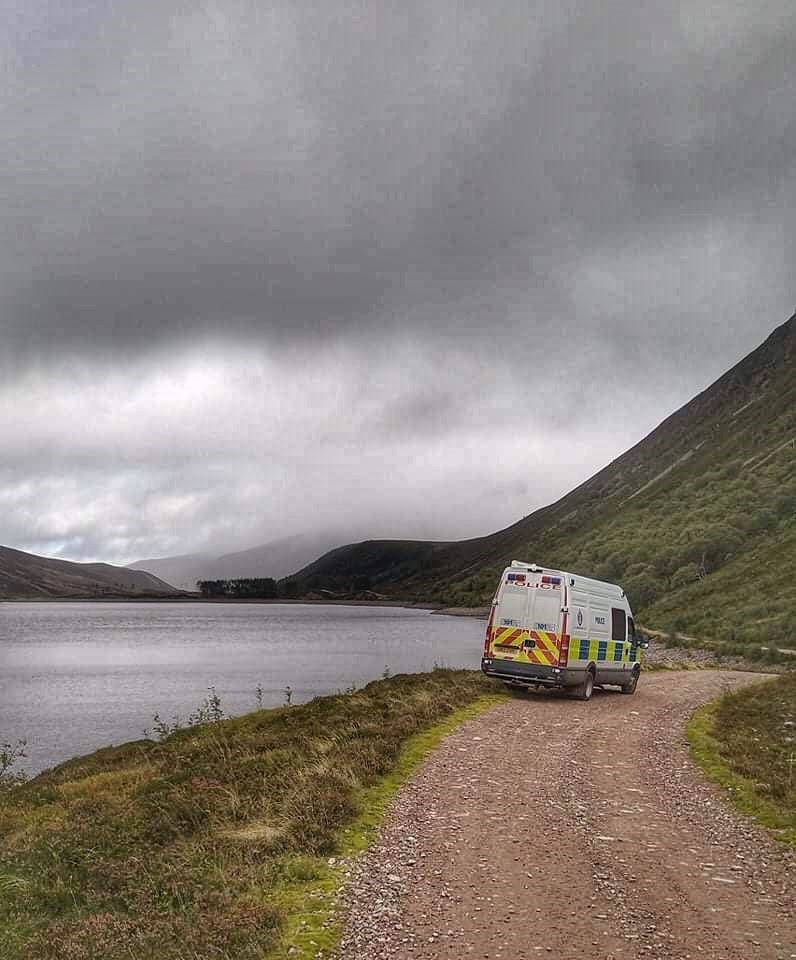 The police dive team parked up by the remote loch to the east of Dalwhinnie.