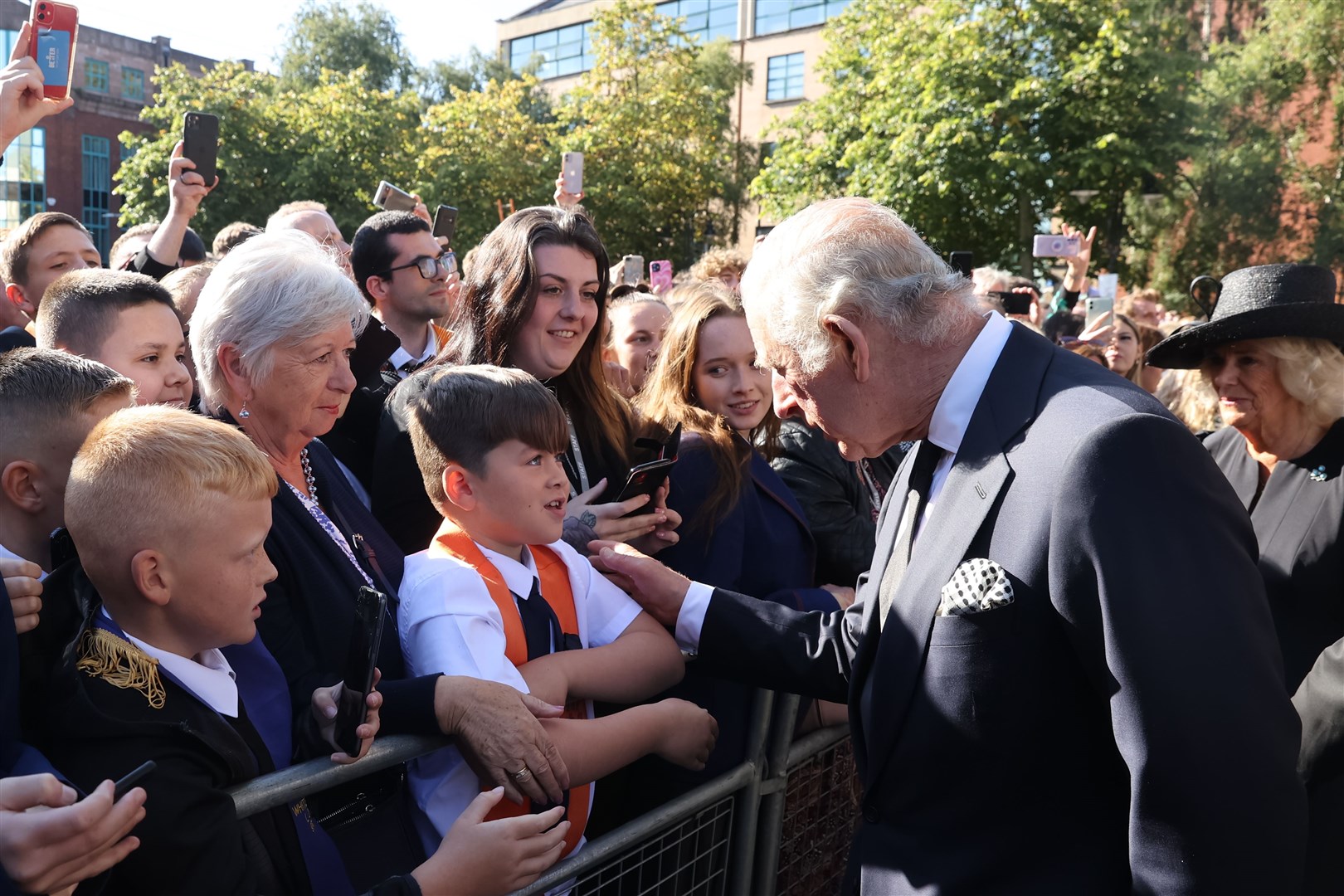 King Charles III meets Noah workman from Ballynafeigh Orange Lodge while on a walkabout (Liam McBurney/PA)