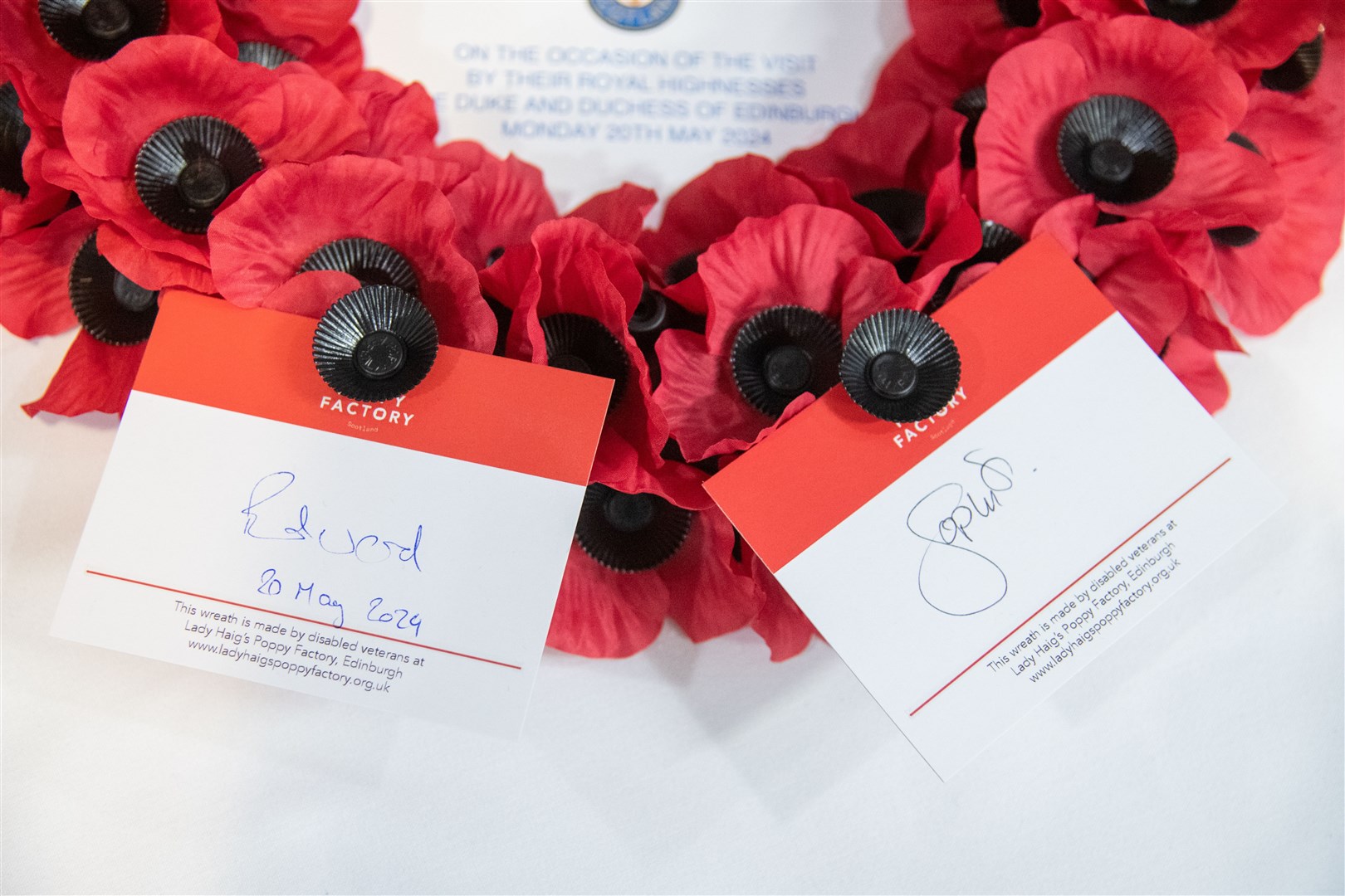 The Duke and Duchess sign cards that will be attached to a wreath - which will be laid at the memorial. Picture: Daniel Forsyth.