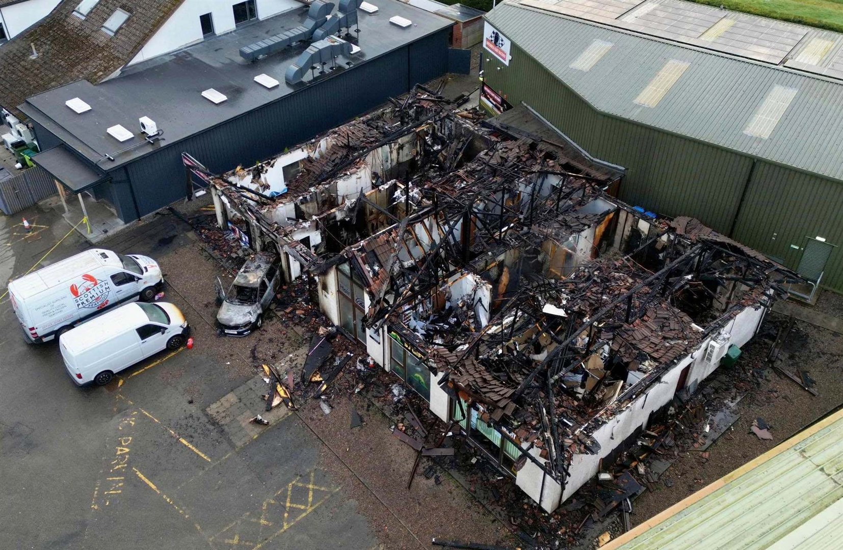 Drone footage reveals the scale of the damage and how close it came to neighbouring buildings. Picture: Walter Geddes.