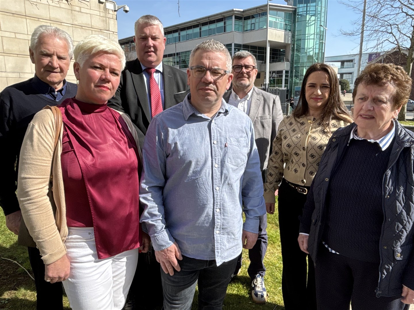 Liam Cairns and members of the Cairns family, their solicitor Fearghal Shiels and Mark Thompson from Relatives for Justice outside Belfast Magistrates’ Court on Friday (Rebecca Black/PA)