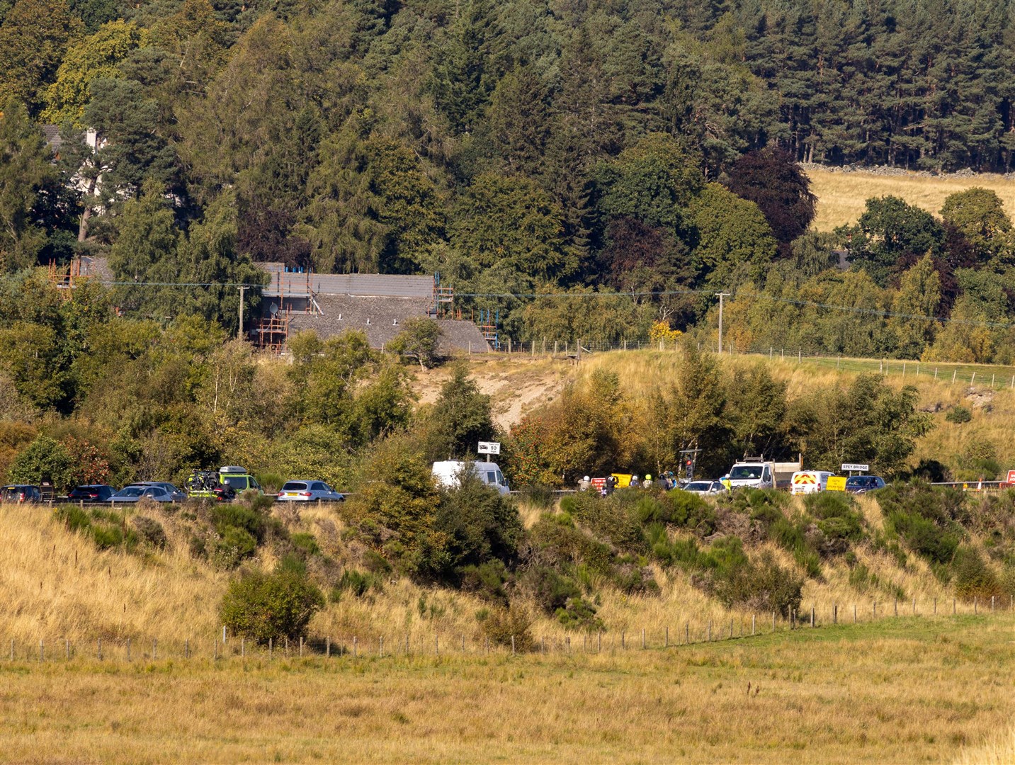 SNAKING THROUGH: Traffic had to slow over the Spey Bridge today outside Kingussie as the road team made hay with the sun shining.