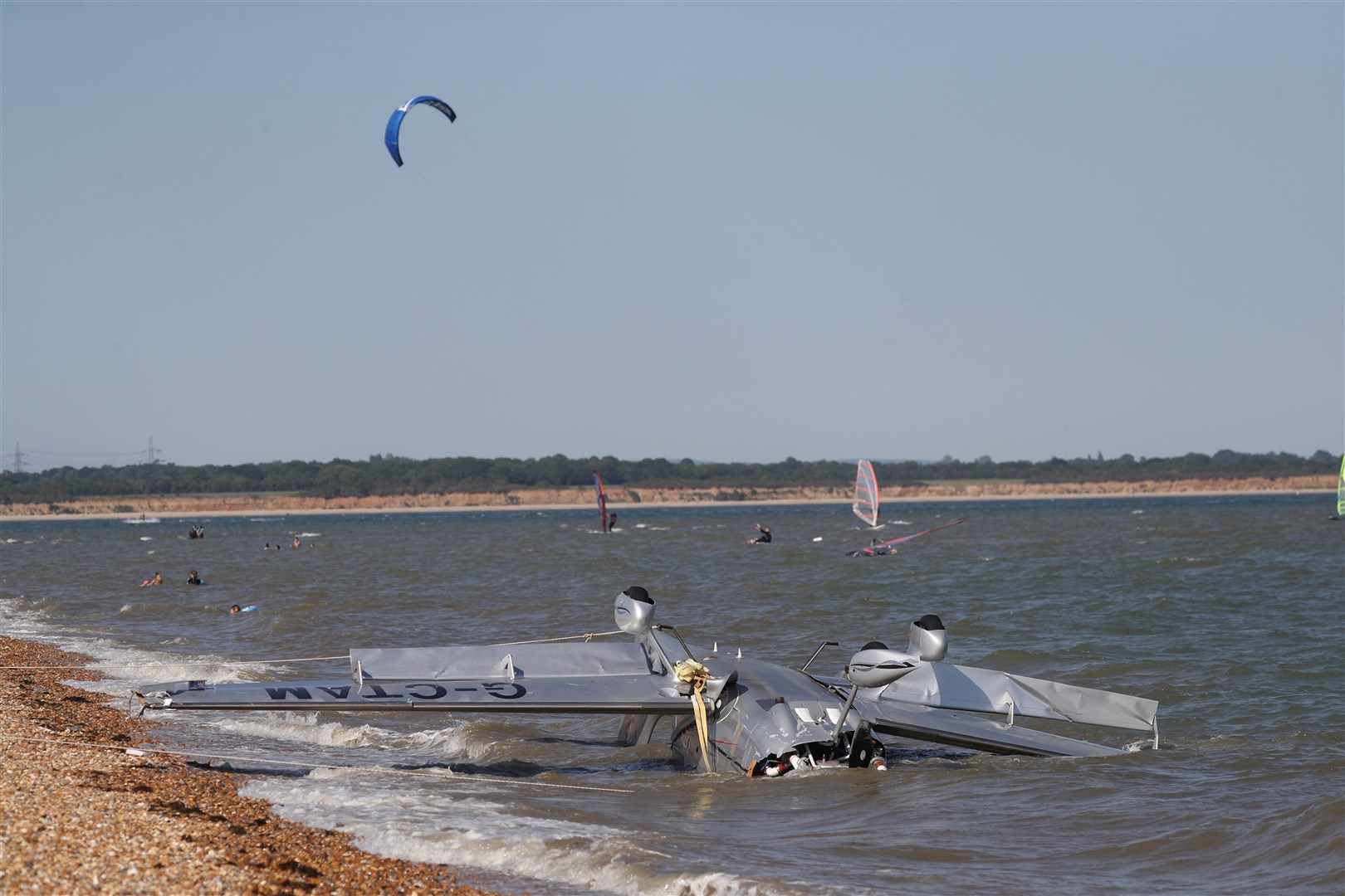 The wreckage of a light plane washed up on the beach near Calshot Spit, Southampton, in May. Two people were rescued (Andrew Matthews/PA)