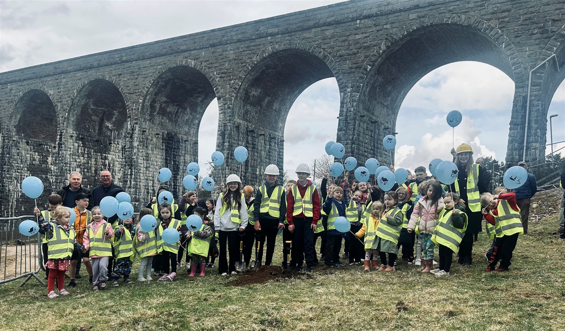 Pupils from Strathdearn Primary School officially break ground on the site, which is next to the railway viaduct at the northern end of Tomatin.