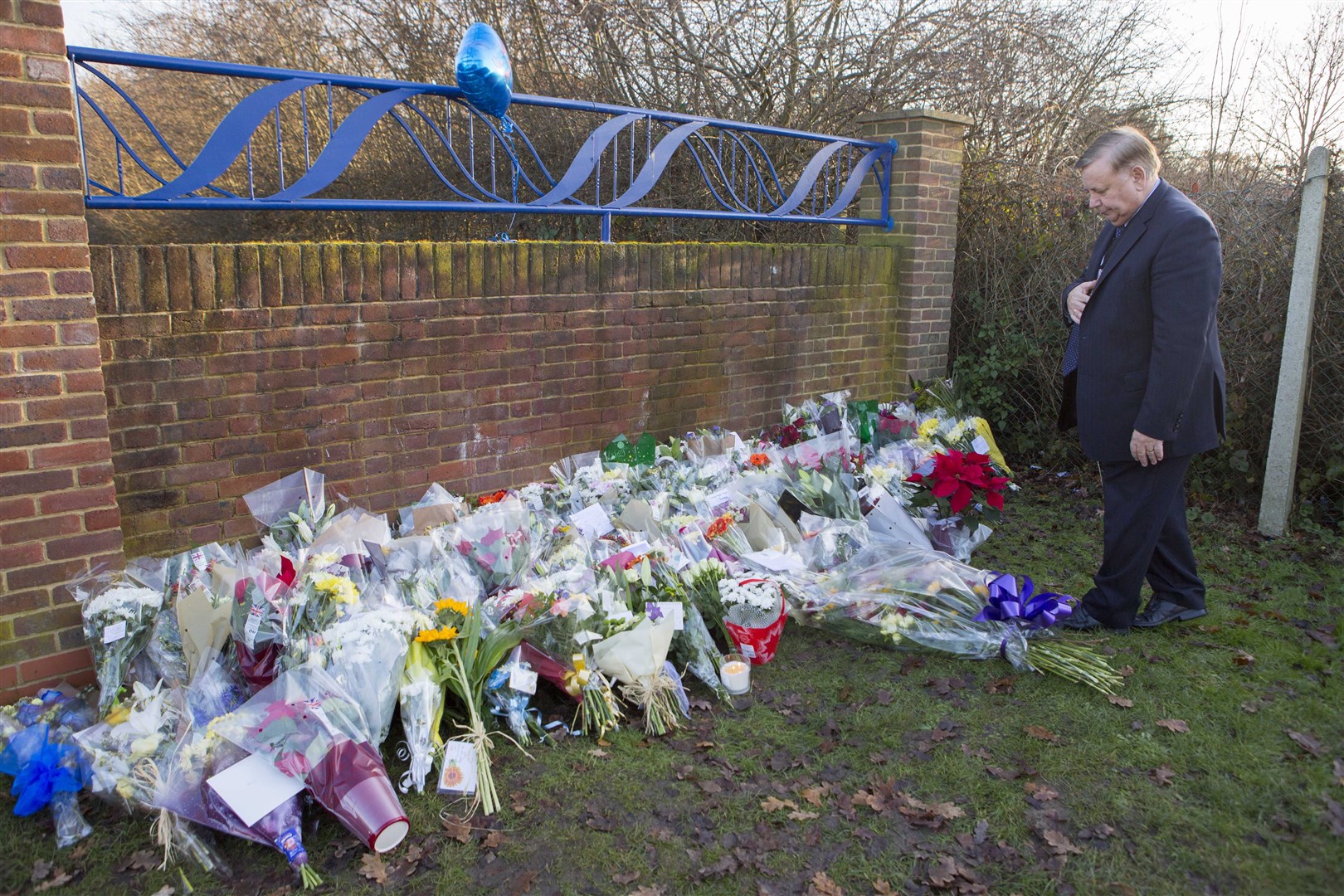 Flowers left at the scene outside Debden Park High School in Loughton (Rick Findler/PA)