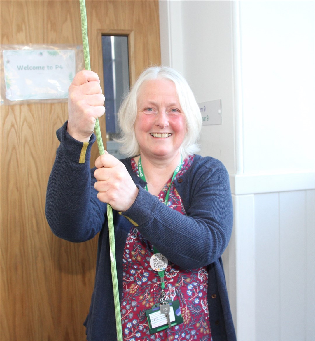 ONE LAST PULL: Mrs Clark ringing the bell for her final assembly.