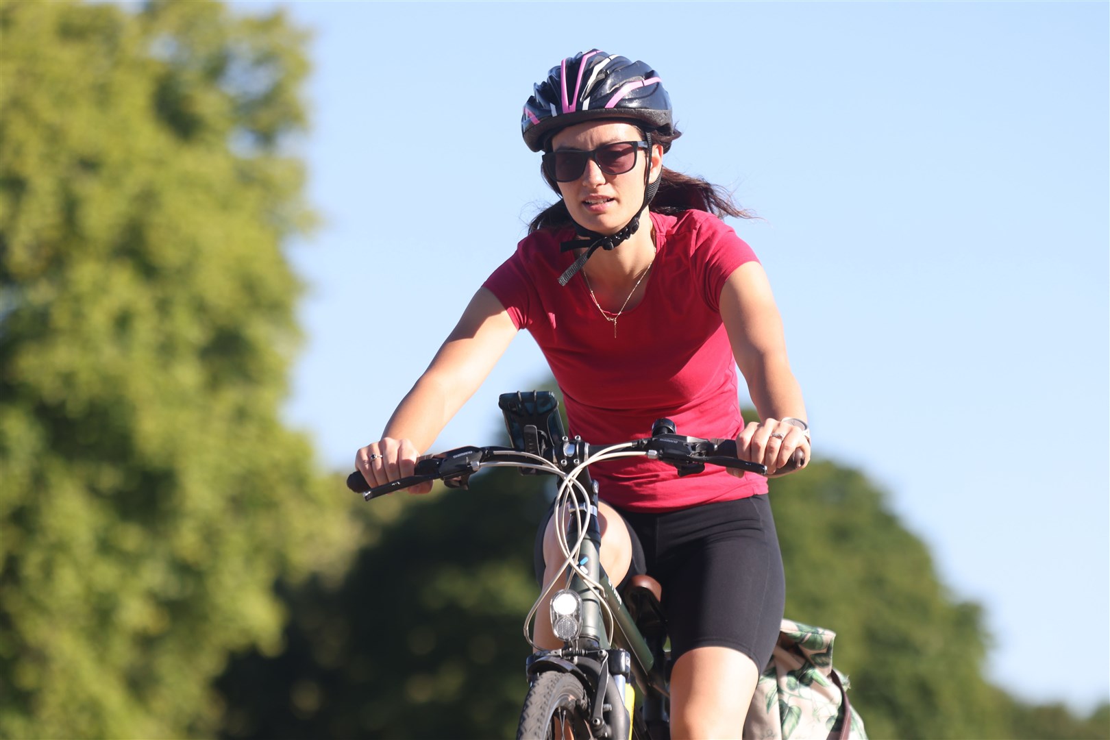 A woman cycles through Kensington Gardens, south London (James Manning/PA)