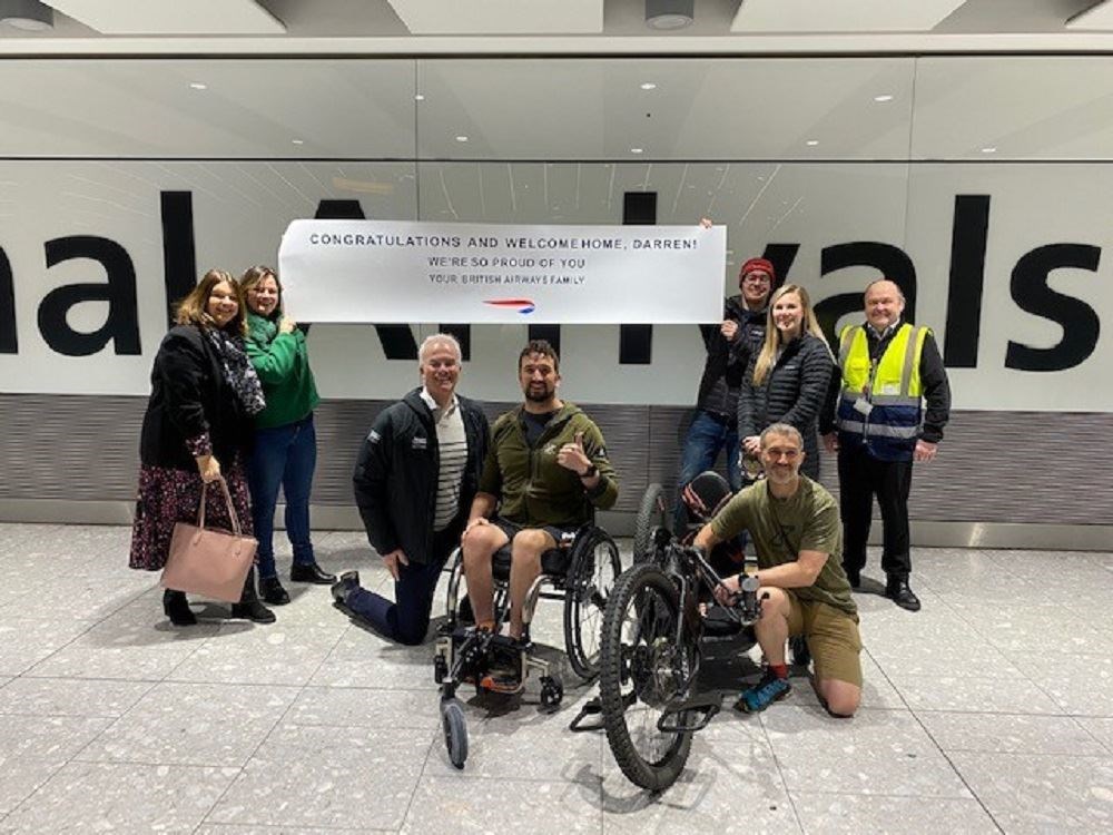 Mr Edwards was welcomed home by the team from British Airways who helped him travel around the world (Carl Simmons/PA)