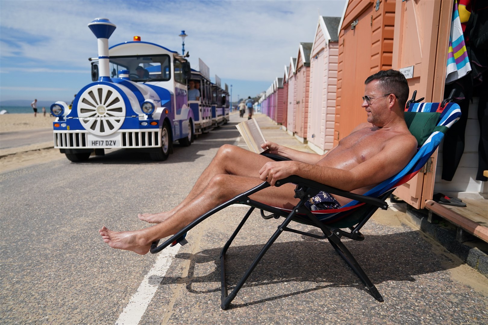 Stuart Henderson enjoys the sunshine from his hut on Bournemouth beach (Andrew Matthews/PA)