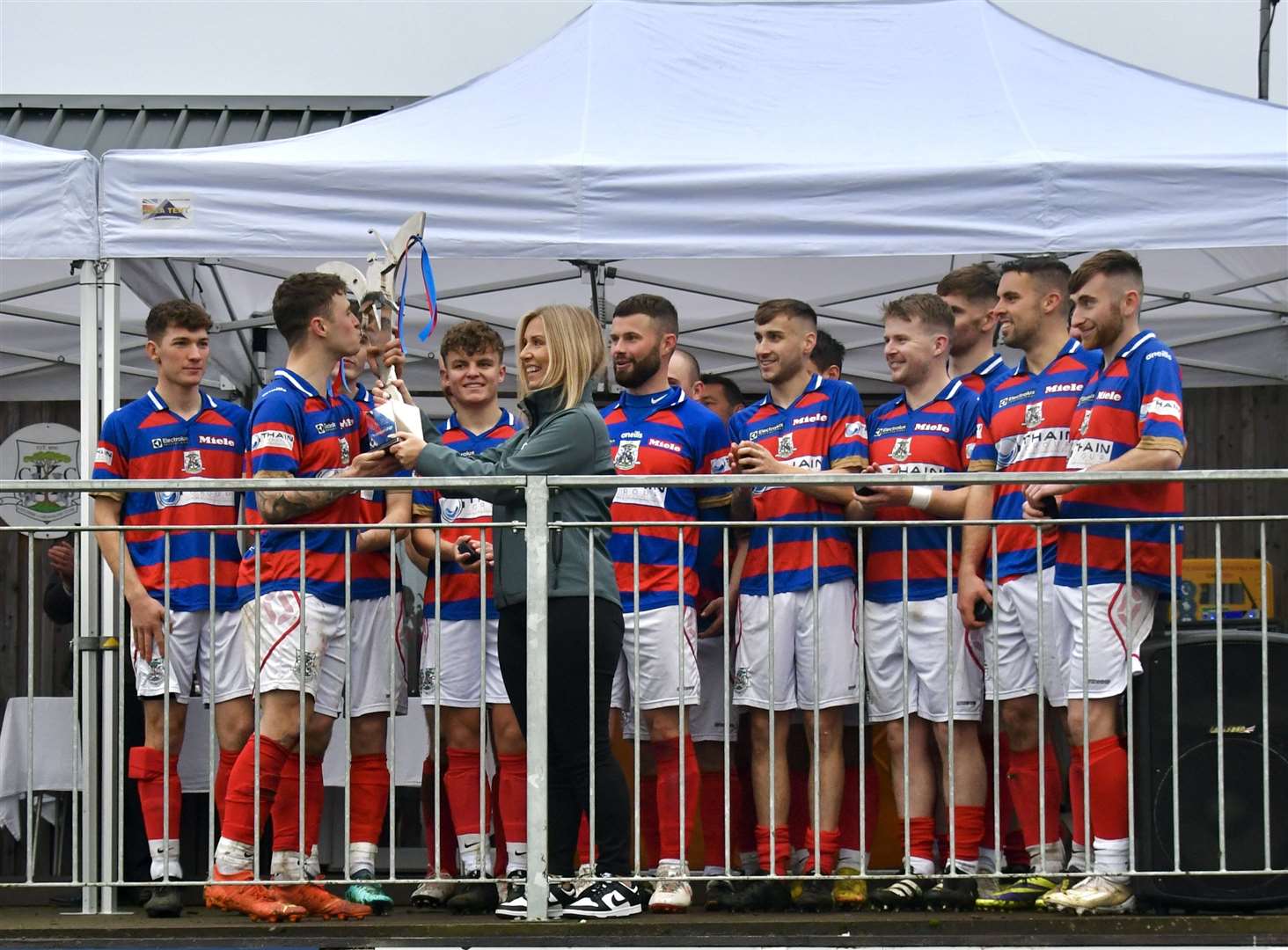 Kingussie lift the Mowi Premiership title trophy on Saturday. Picture: Fiona Young.