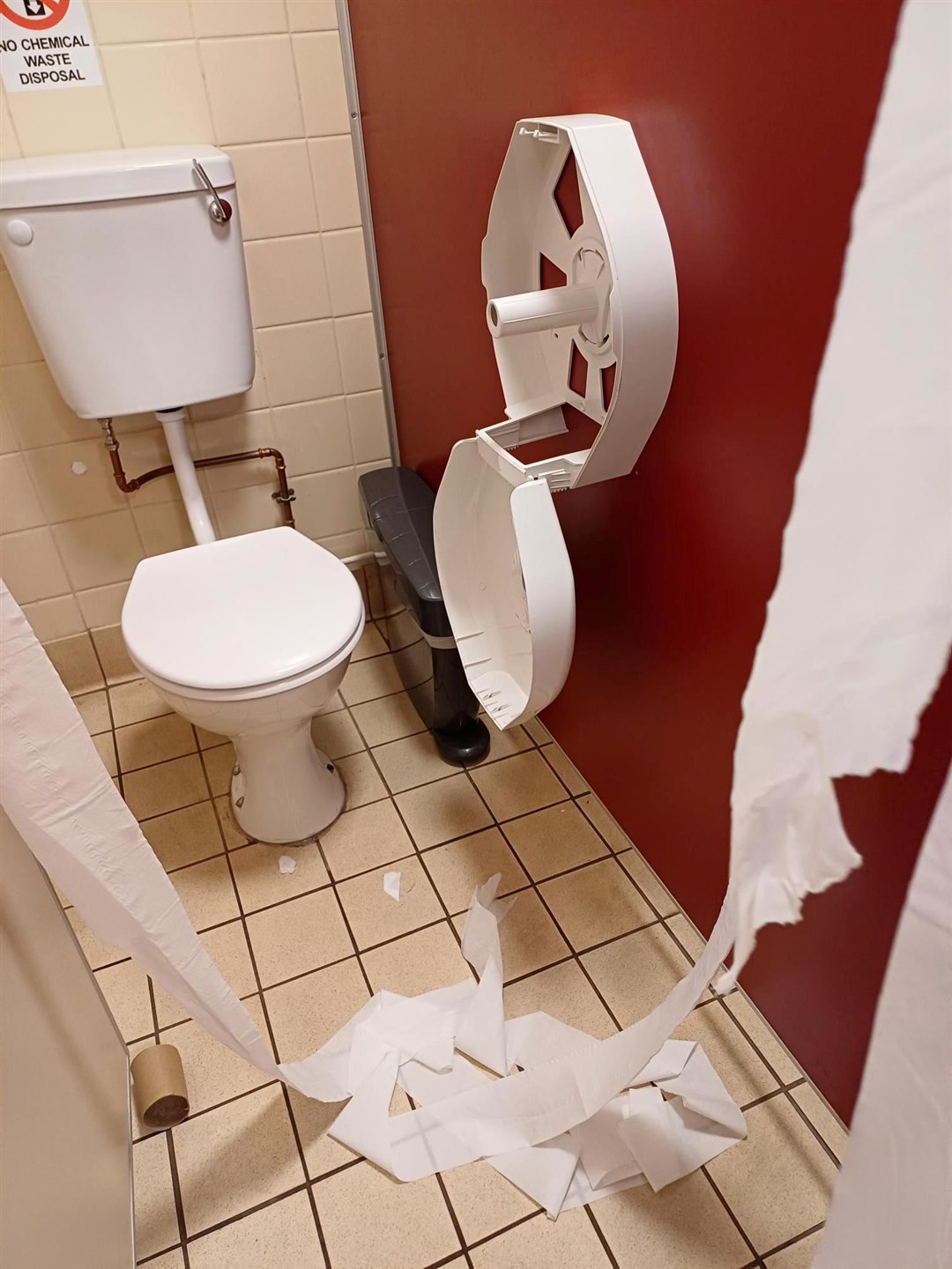 A toilet roll holder torn open.