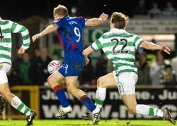Richie Foran is felled by Glenn Loovans for the penalty.