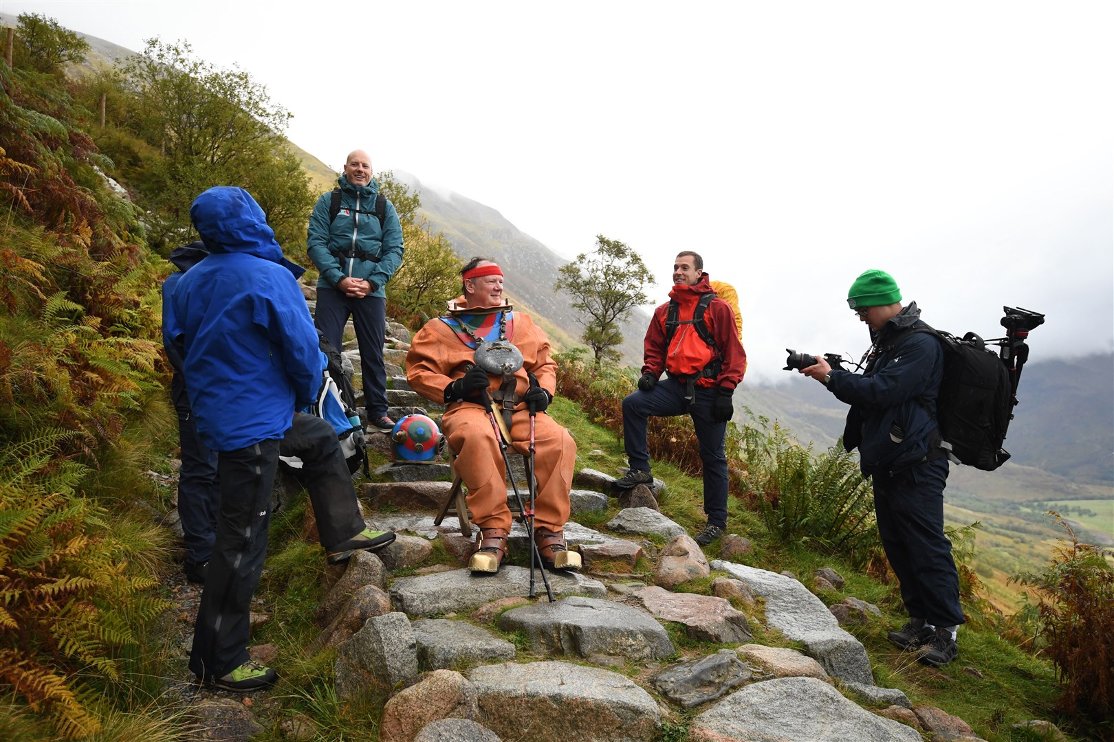 Lloyd Scott takes a rest with his support team on Ben Nevis (Joe Giddens/PA)