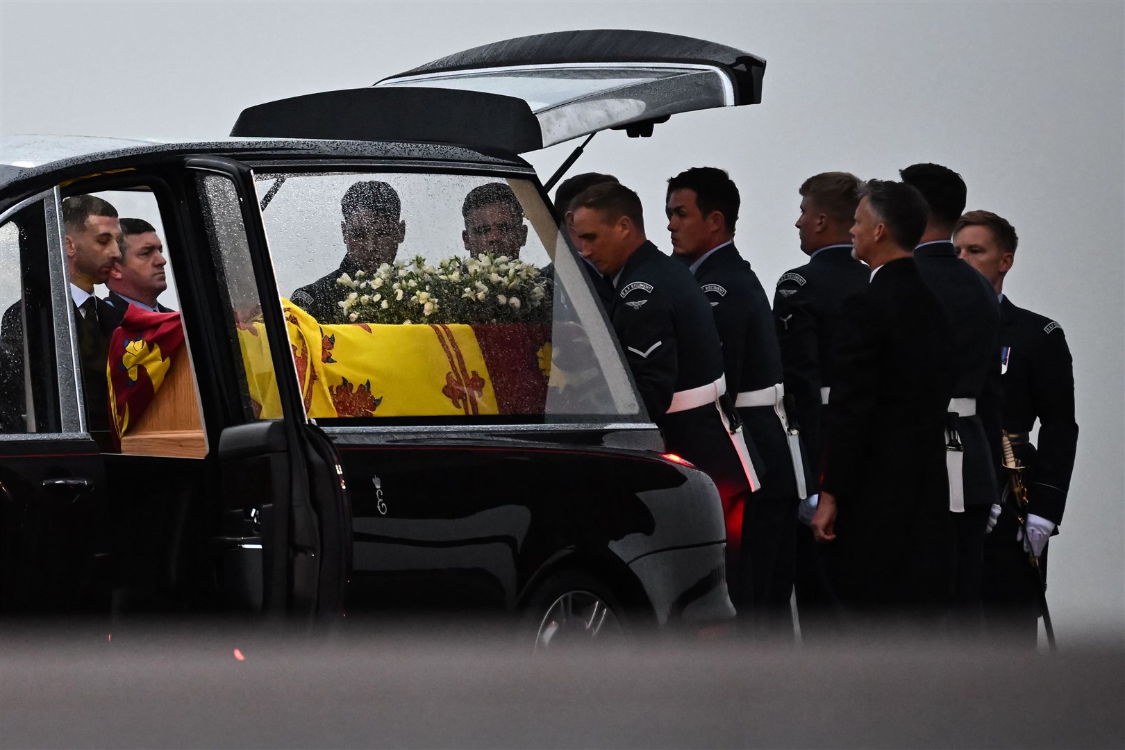 The bearer party from the Queen’s Colour Squadron (63 Squadron RAF Regiment) carry the Queen’s coffin to the waiting hearse at RAF Northolt (Ben Stansall/PA)
