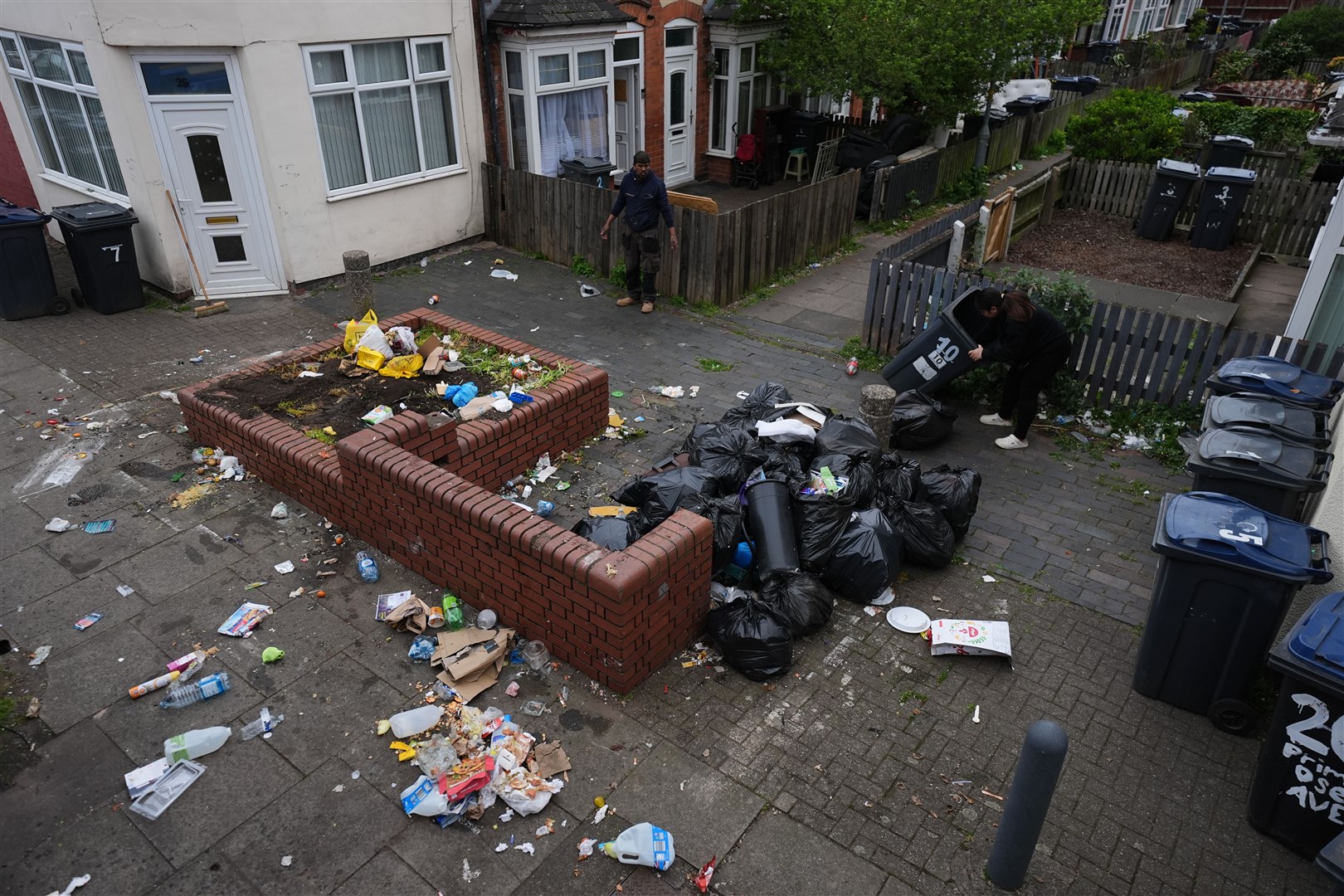Rubbish bags are taken away on Poplar Road in Birmingham. (Jacob King/PA)