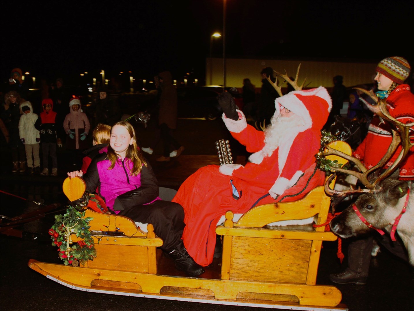 Tilly Smith (right) lends Santa and his reindeer a hand at Aviemore as the big parade get under way