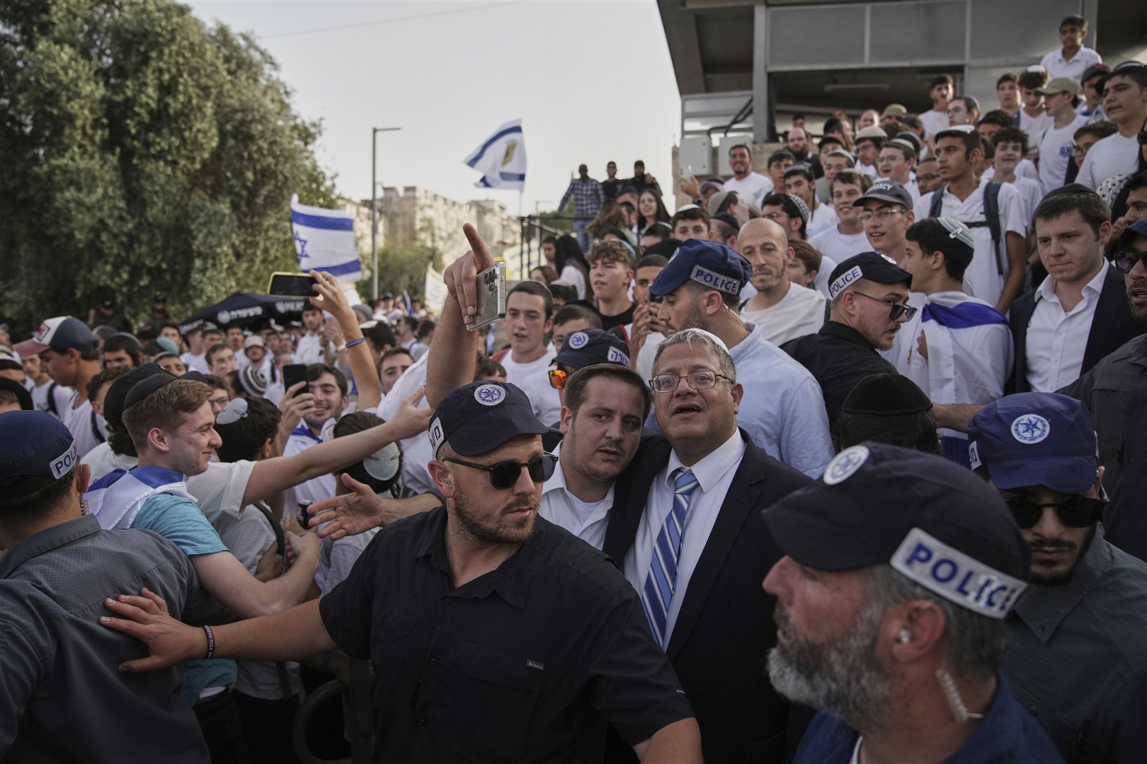 Surrounded by security guards, Israel’s National Security Minister, Itamar Ben-Gvir, centre, has been sanctioned by the Government (Leo Correa/AP)