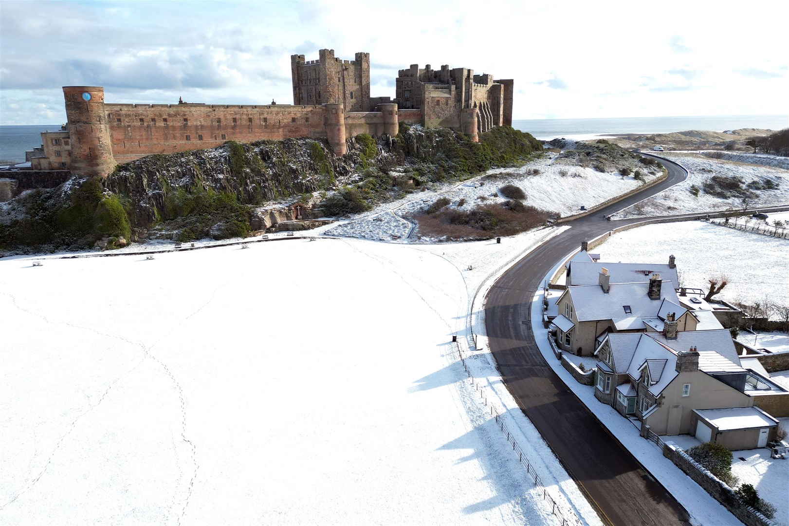 Bamburgh Castle in Northumberland was surrounded by snow (Owen Humphreys/PA)