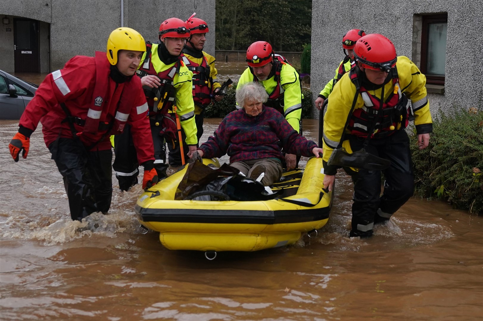 Members of the emergency services help local residents to safety in Brechin (Andrew Milligan/PA)
