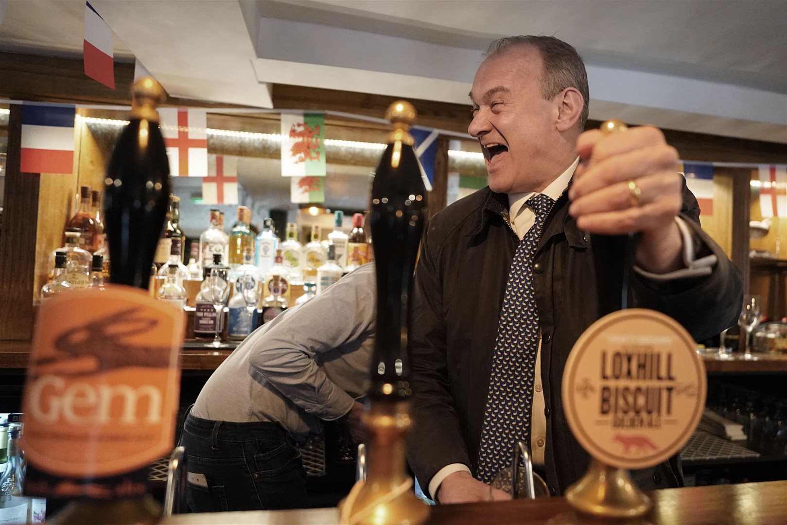 Liberal Democrat leader Sir Ed Davey pulls a pint in The Star in Witley, Surrey (Stefan Rousseau/PA)