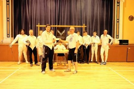 Tom Hoffmann (left) receives a cheque from Dingwall Fencing Club treasurer Ian Michael for £300 to go towards his costs.