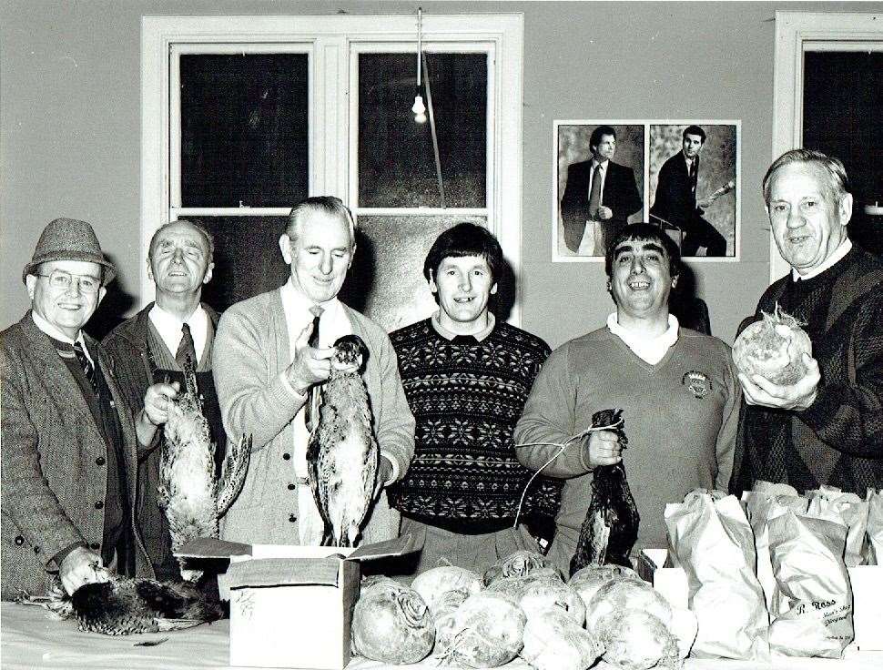 Denis Swanson (second from left) at an Inverness sale of work in aid of club funds.