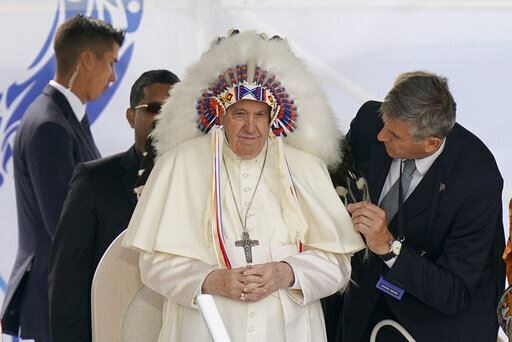 Francis dons a headdress gifted to him during a visit with Indigenous peoples at Maskwaci in Alberta, Canada (Eric Gay/AP)