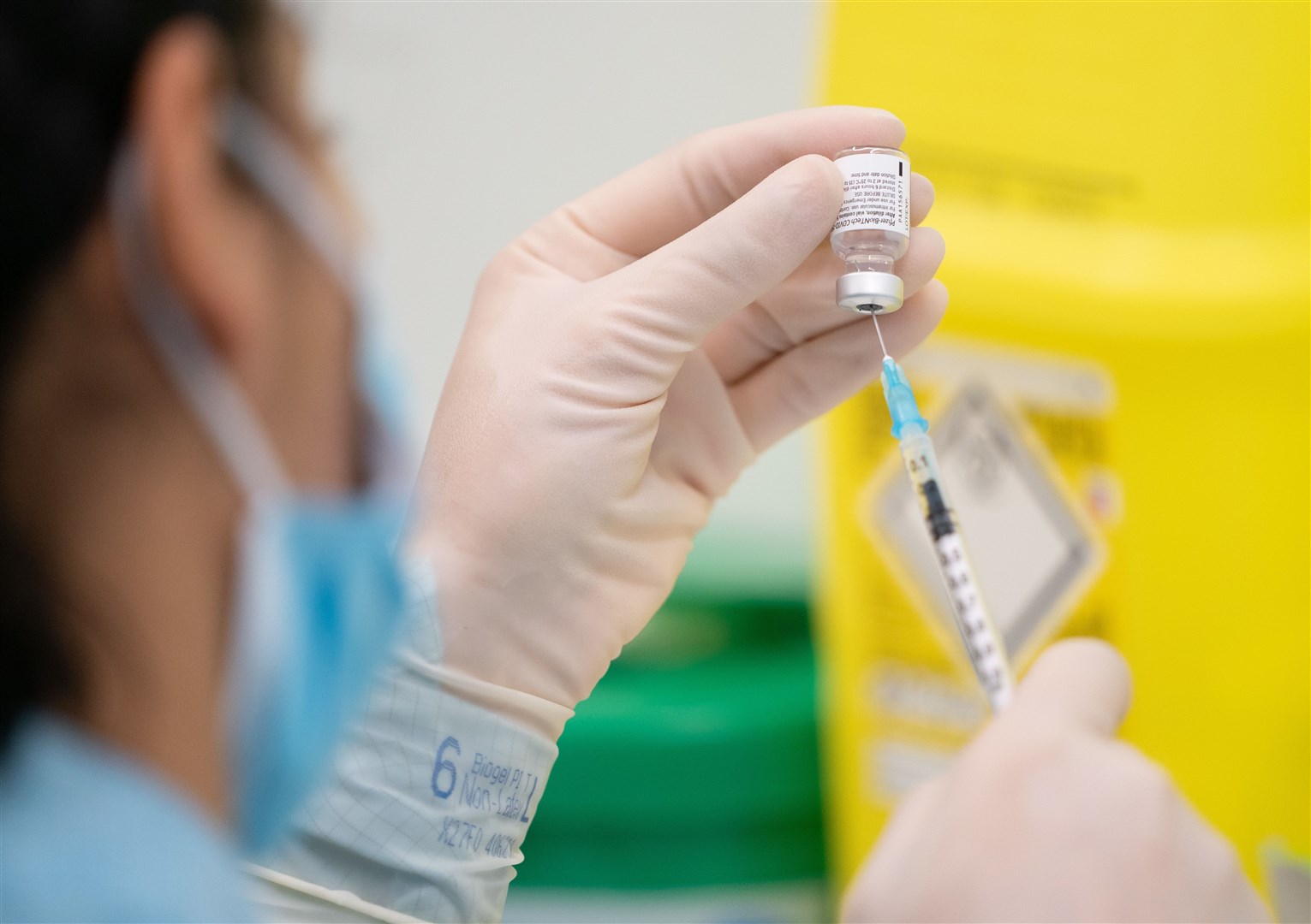 A member of medical staff prepares a Pfizer-BioNTech Covid-19 vaccine at The Vaccination Hub at Croydon University Hospital, south London (Dan Charity/The Sun)