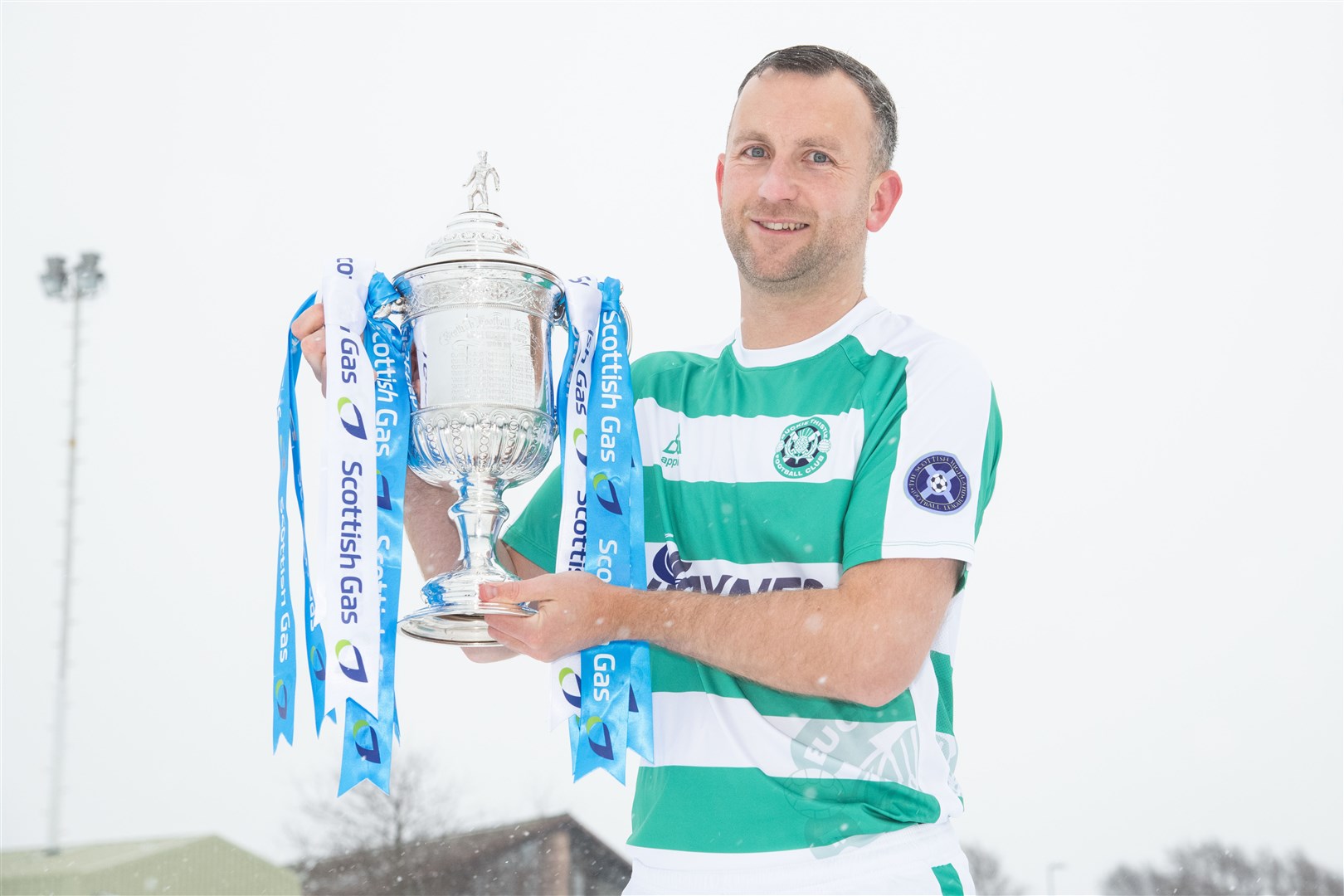 Buckie Thistle striker John Mcleod shows off The Scottish Gas Scottish Cup at a snow-covered Victoria Park ahead of the big game. Picture: Daniel Forsyth.