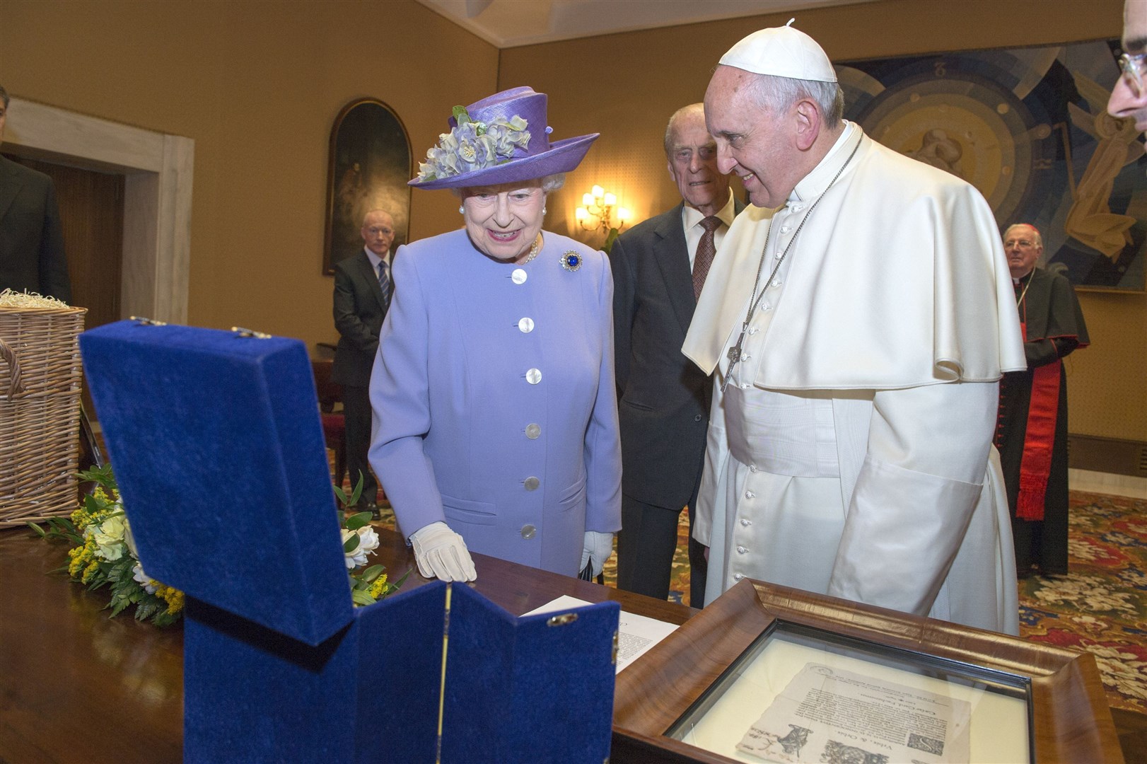 Queen Elizabeth II with Pope Francis look at a papal gift to Prince George as they met at the Vatican in 2014 (Arthur Edwards/The Sun/PA)