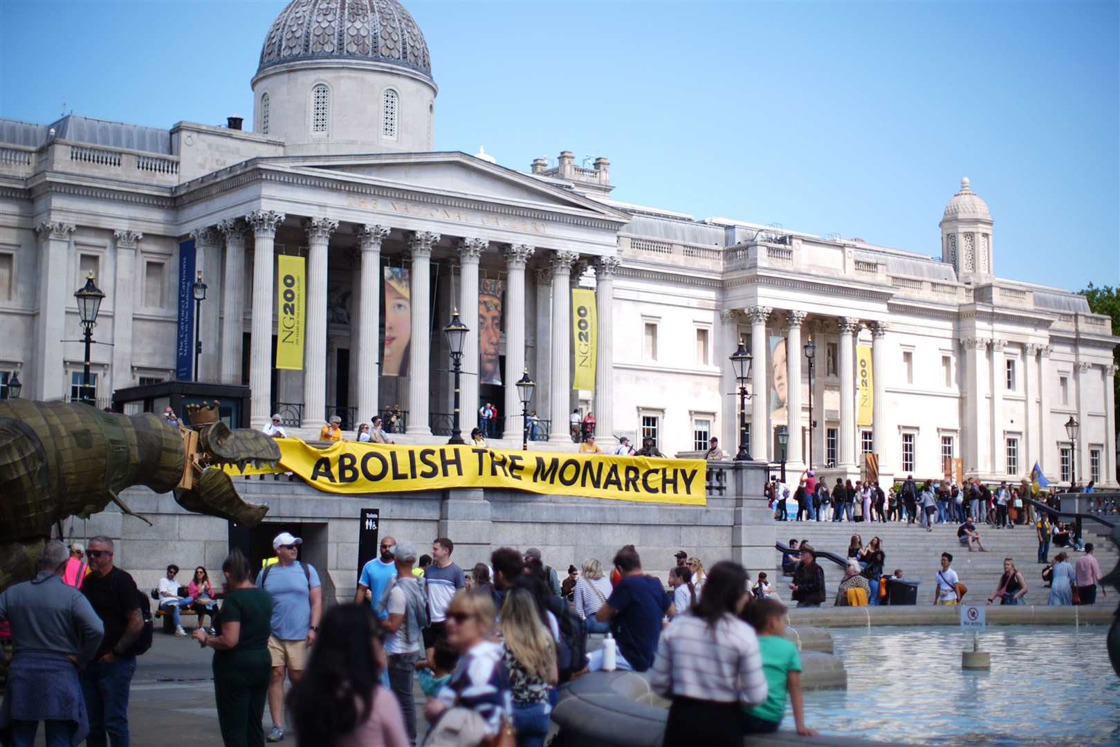 Protesters hung up a large banner bearing the words ‘abolish the monarchy’ in Trafalgar Square (James Manning/PA)