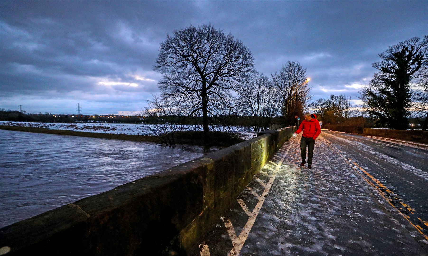 A council worker in Didsbury checks a bridge over the River Mersey for damage after heavy rain (Peter Byrne/PA)