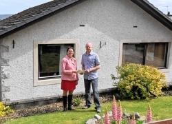 Mr Beange receives his vouchers from local Highland councillor Jaci Douglas