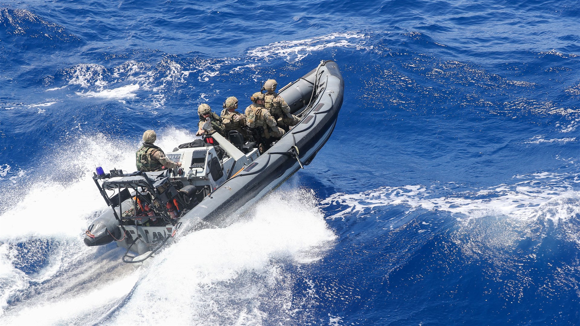 Royal Marines from 539 Raiding Squadron deploy to intercept a boat in the Caribbean Sea during an operation against drug smugglers (LPhot Oates/Royal Navy/PA)