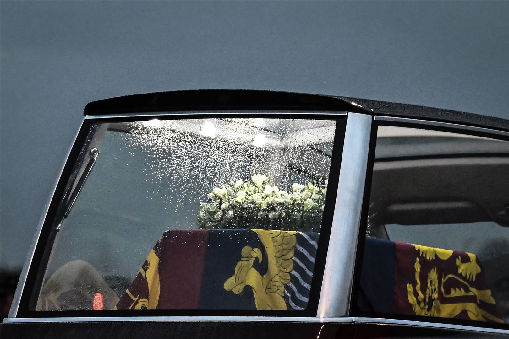 The Queen’s coffin illuminated with lights in the new state hearse (Ben Stansall/PA)