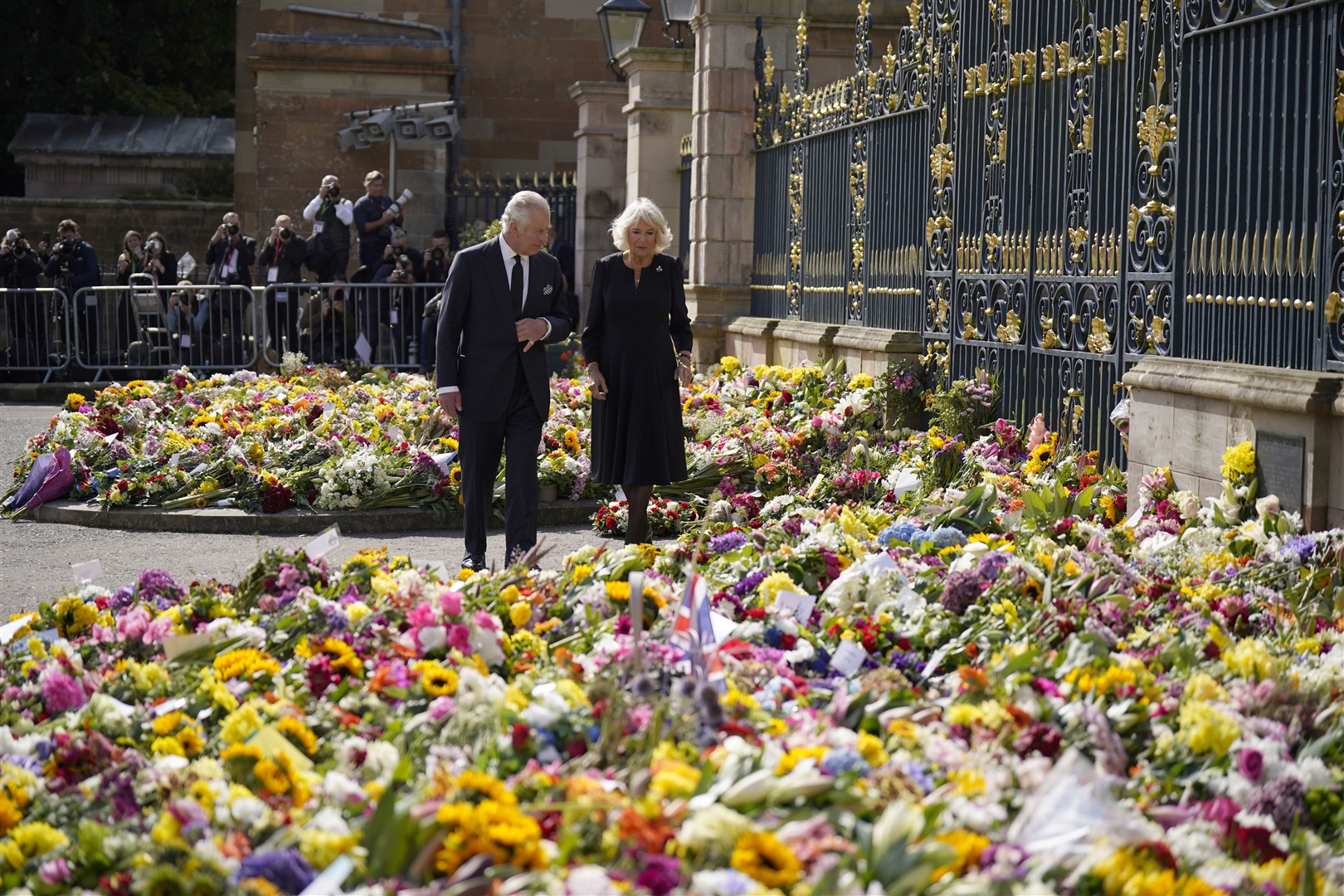 The King and the Queen Consort view floral tributes left outside Hillsborough Castle (Niall Carson/PA)