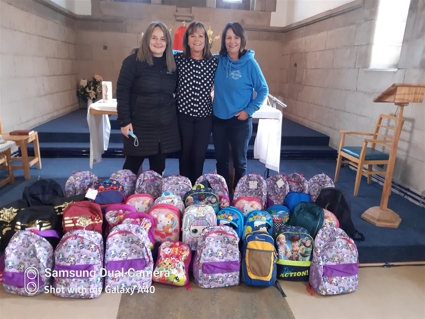 Derick’s family delivering the 39 backpacks: Romy Paxton, Karen Smith and Trish Fell.