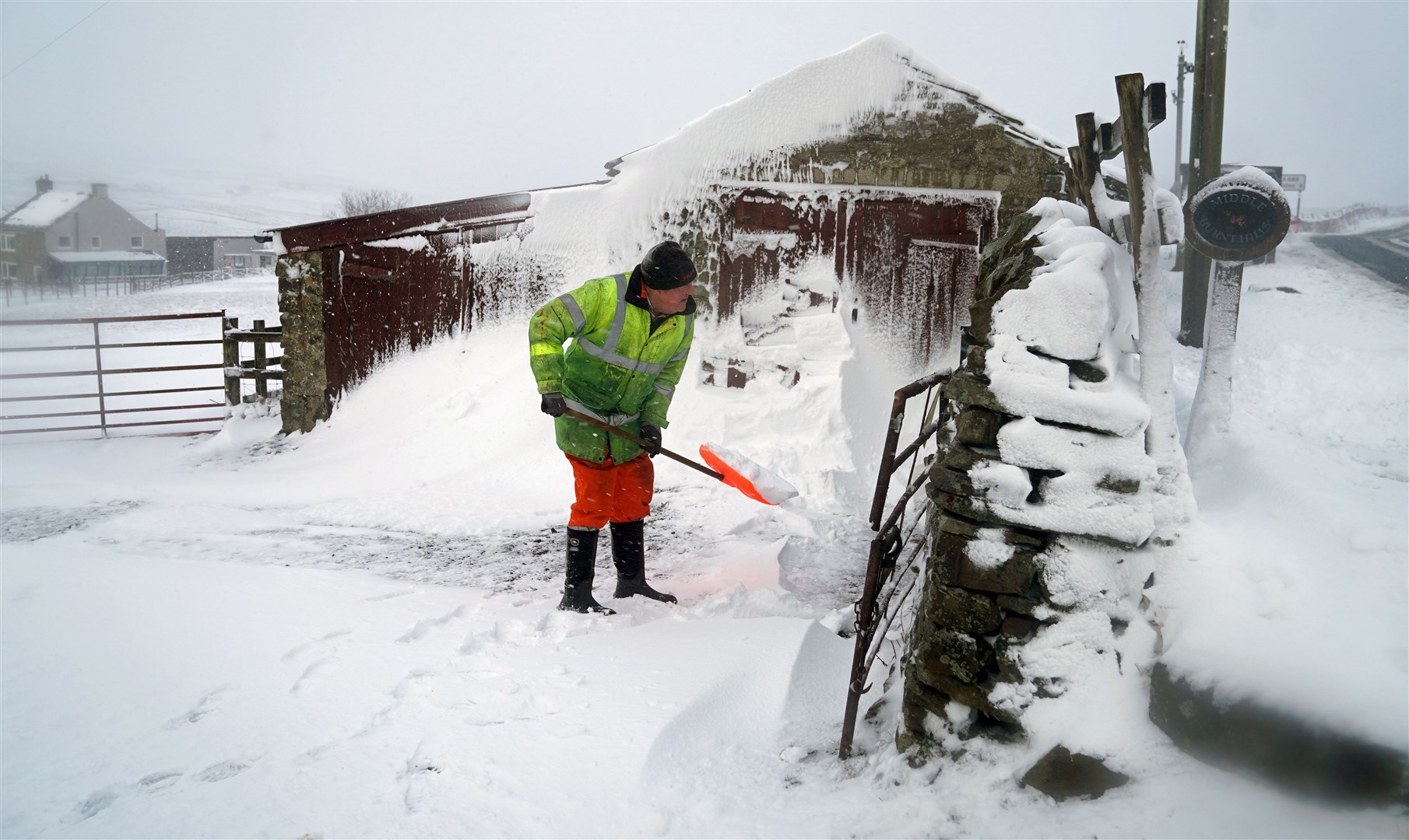 Ken Emerson, 76, clears a snow drift in Lanehead, Co Durham (Owen Humphreys/PA)